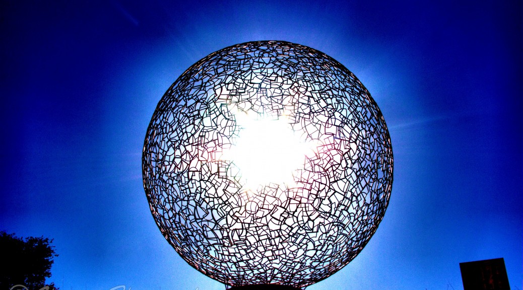 Sun rising behind Sphere 112 by Ivan McLean - Newport Beach Civic Center Park
